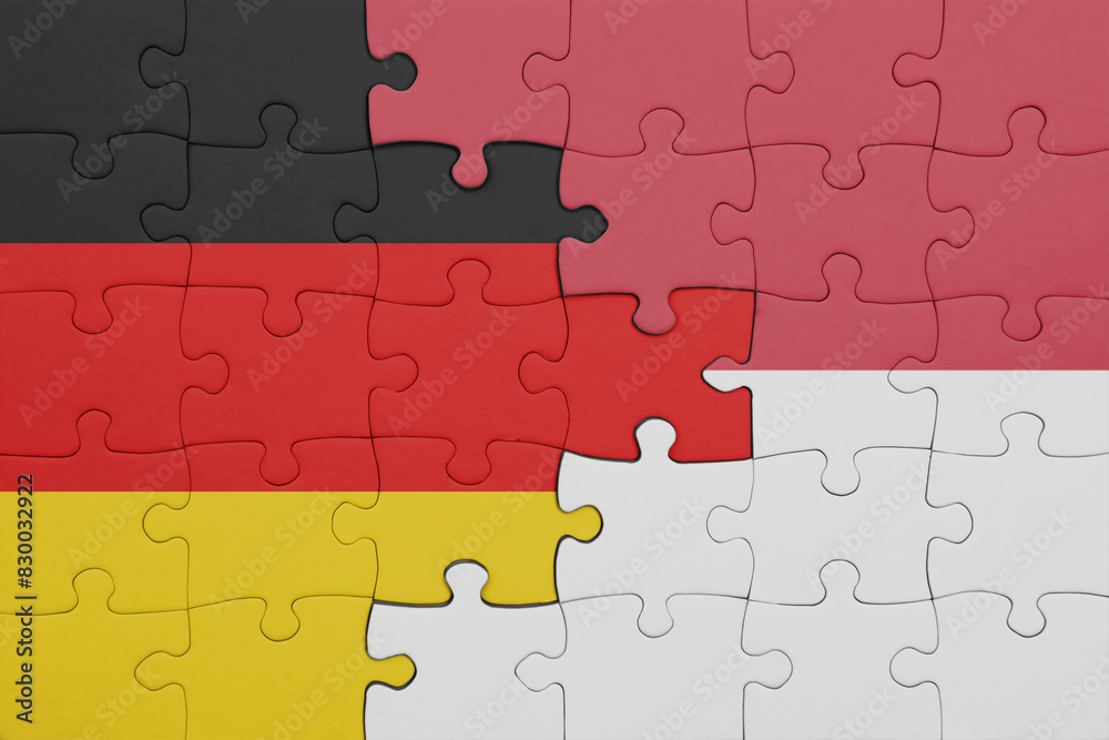 puzzle with the colourful national flag of indonesia and flag of germany. puzzle with the colourful national flag of indonesia and flag of germany.