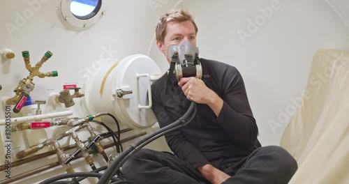 Military man in hyperbaric chamber using BIBS mask