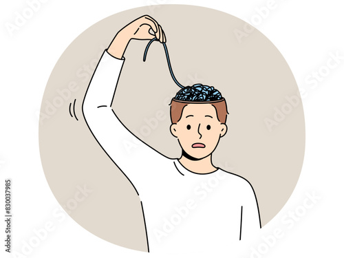 Man with mental problems associated with confusion needs help of psychologist to improve mental health. Young guy is confused trying to unravel threads in brain and looks into camera