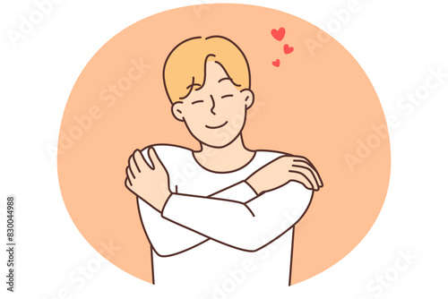 Smiling man hug himself show self-love
