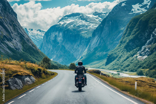 Motorcyclist navigates winding mountain roads, soaking in the scenic beauty  photo