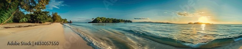 A panoramic shot of a tropical paradise beach with crystal-clear turquoise water  white sandy shores  and lush greenery. The sun sets in the background  creating a warm  inviting atmosphere.