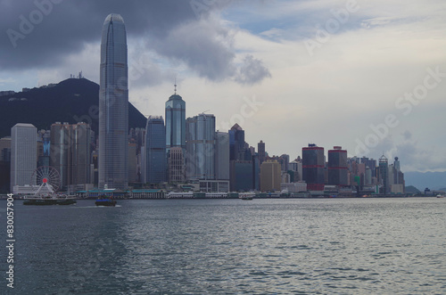 Panoramic skyline silhouette view of Hongkong Hong Kong Victoria Harbor and port infrastructure bay scenic landscape seascape scenery during twilight blue hour in China