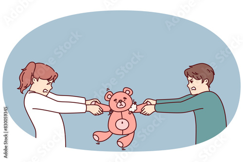 Preteen boy and girl argue over right to play with teddy bear in attempt to take toy away from rival. Kindergarten children are unwilling to share toys after disagreement or conflict