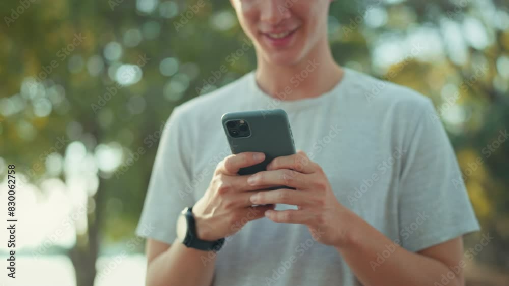 Close-up hand of man holding mobile phone at public park, Male using smartphone, checking mobile fitness