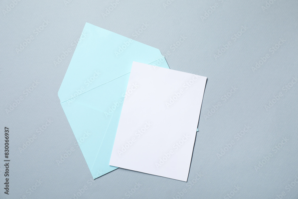 Letter envelope and card on grey background, top view. Space for text Letter envelope and card on grey background, top view. Space for text