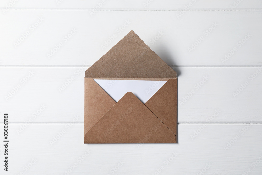 Letter envelope with card on white wooden table, top view Letter envelope with card on white wooden table, top view