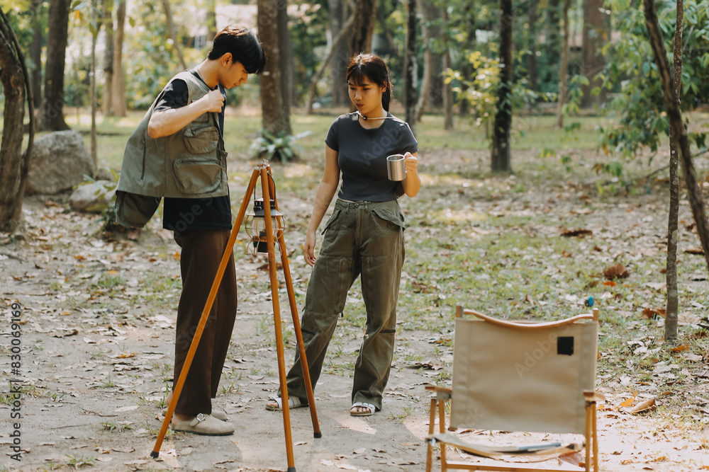Asian couple sweet in tent inside on they camping trip, traveller relax and sleep togather in out door and camping trip Asian couple sweet in tent inside on they camping trip, traveller relax and sleep togather in out door and camping trip