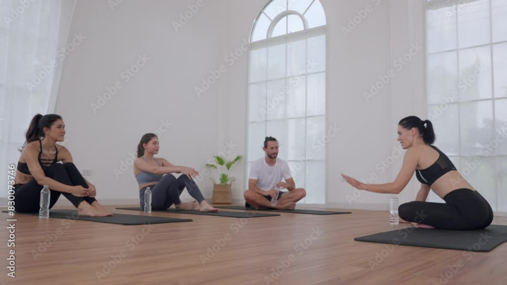 Group Yoga Class in a Bright Studio Taking a Break Group Yoga Class in a Bright Studio Taking a Break