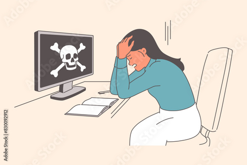 Woman victim of hacker attack is upset because computer was hacked sitting near coin with skull