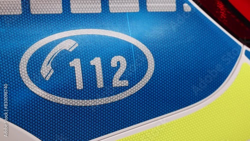 Concept 4K video with the logo sign of Politia Romana placed on a police car with emergency 112 number on it. photo