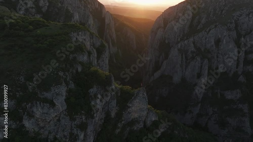 Turzii Gorges (Cheile Turzii in Romanian) aerial 4k video. Beautiful sunset landscape with this amazing mountain landmark from Apuseni Mountains. Travel to Transylvania, Romania. photo