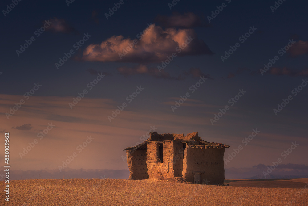 Ruins of an old dovecote in Arconada, Tierra de Campos, Palencia, with the evening sunlight touching the mud walls Ruins of an old dovecote in Arconada, Tierra de Campos, Palencia, with the evening sunlight touching the mud walls