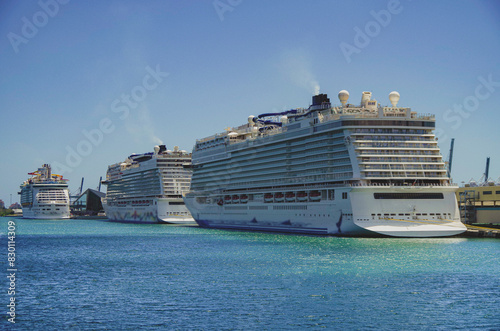 Big modern cruiseship or cruise ship liner Bliss in Port of Miami, Florida with downtown skyline and skyscrapers in background waiting for passengers for Caribbean cruising holiday	