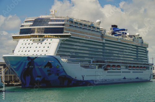 Big modern cruiseship or cruise ship liner Bliss in Port of Miami, Florida with downtown skyline and skyscrapers in background waiting for passengers for Caribbean cruising holiday photo