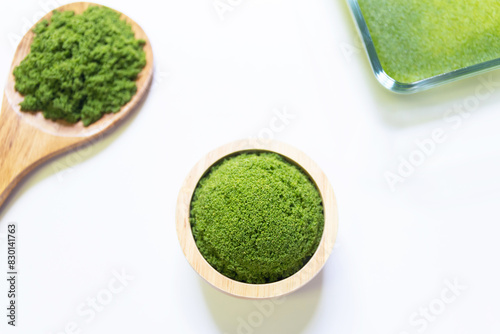 Wolffia globosa in wooden bowl isolated on white background. Wolffia is the nutrient-rich plant-based source of protein and omega3 and vital minerals like zinc, calcium, iron, B12 and so much more.