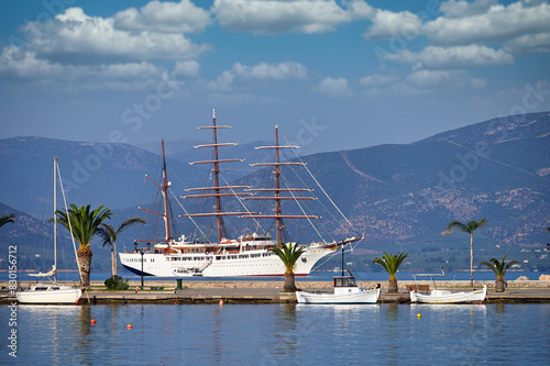 Sailing ship and small white fishing boats in the harbor Nafplio Greece