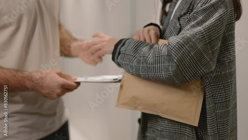 Close-up of hands exchanging an envelope, implying confidential or important document delivery between two people.