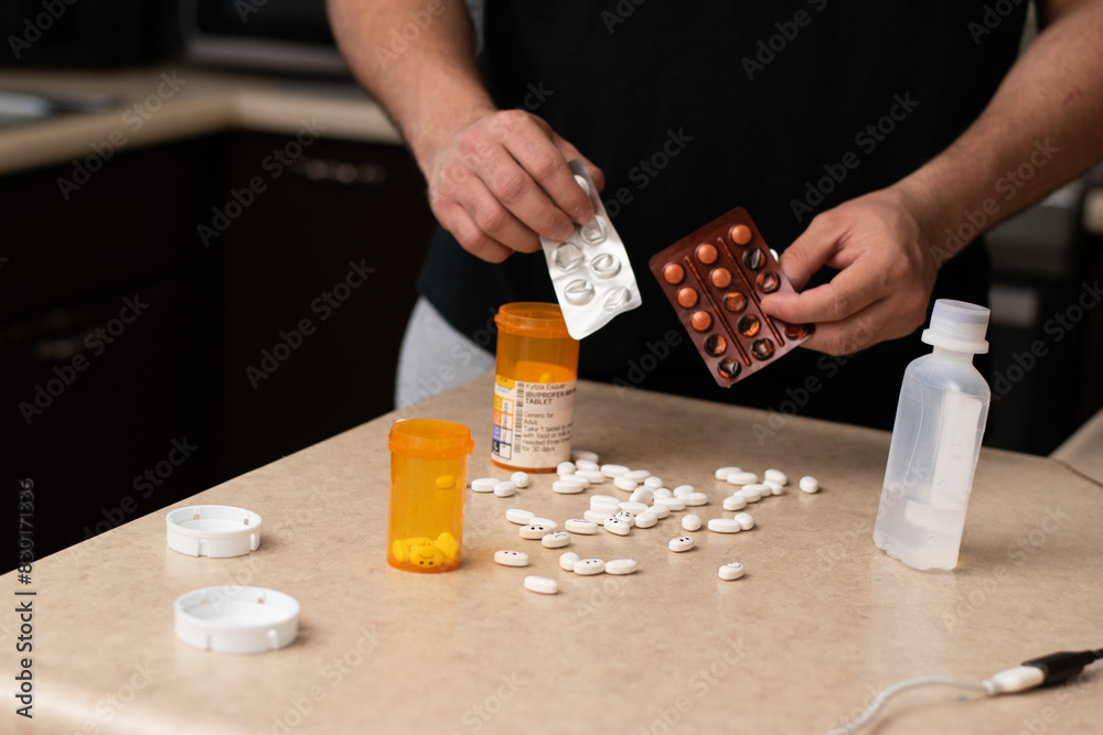 Man desesperated and addicted with many pills and syringes front him in a table Man desesperated and addicted with many pills and syringes front him in a table