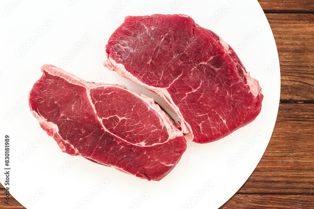 Obraz premium A piece of premium meat, striploin steak on a wooden table