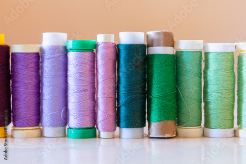 Variety of colorful thread spools on a table