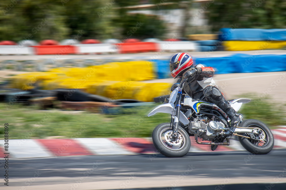 Motorcycle Racer Accelerating on Track