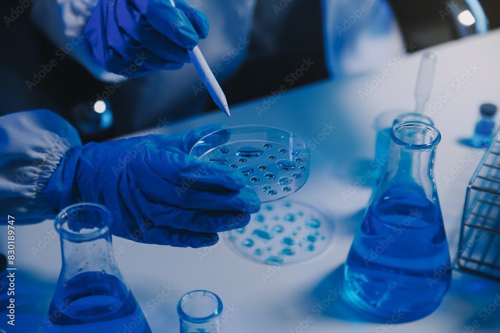 chemist,scientist hand dropping chemical liquid into test tube, science research and development concept chemist,scientist hand dropping chemical liquid into test tube, science research and development concept