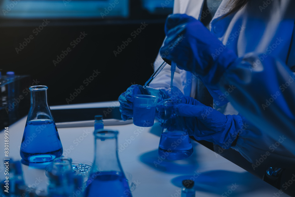 chemist,scientist hand dropping chemical liquid into test tube, science research and development concept chemist,scientist hand dropping chemical liquid into test tube, science research and development concept
