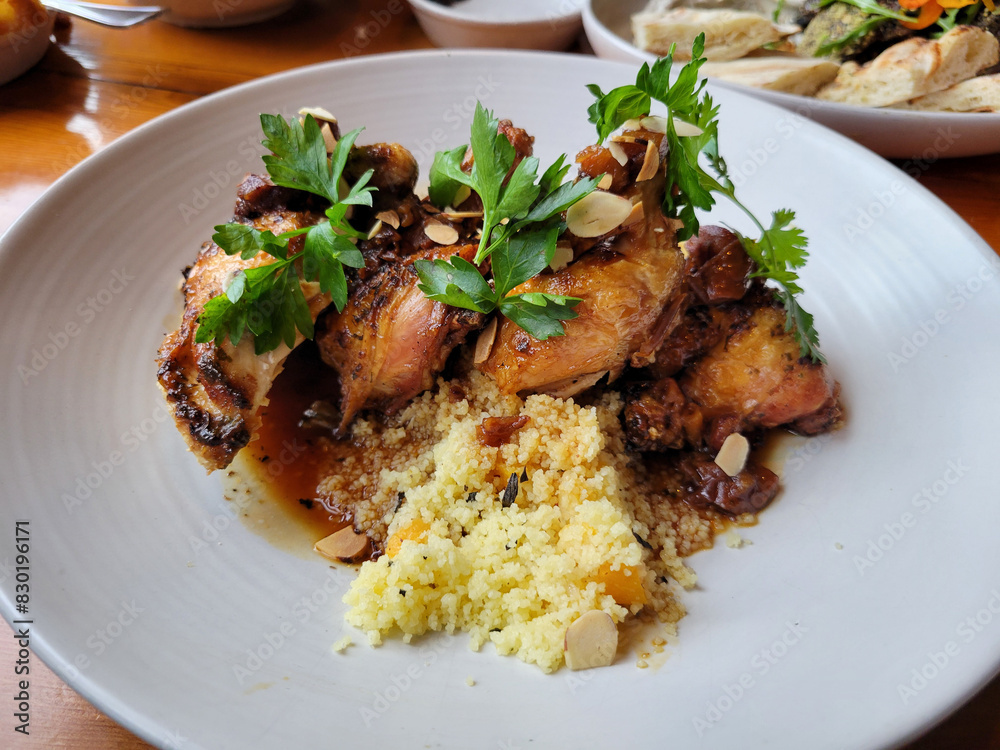 A dish of roast chicken with cous cous on a plate A dish of roast chicken with cous cous on a plate