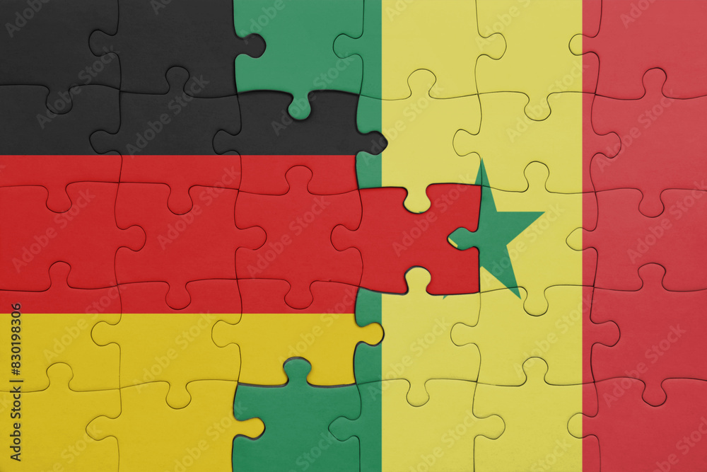 puzzle with the colourful national flag of senegal and flag of germany. puzzle with the colourful national flag of senegal and flag of germany.