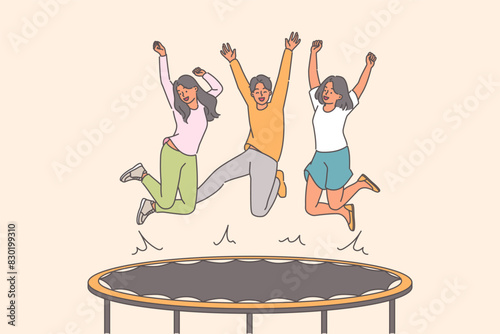 Happy people jumping on trampoline enjoying opportunity for active recreation with friends