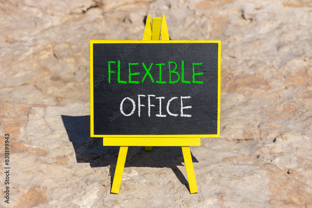 Fototapeta premium Flexible office symbol. Concept words Flexible office on beautiful yellow blackboard. Beautiful red stone beach background. Business Flexible office concept. Copy space.