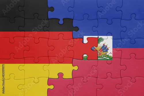 puzzle with the colourful national flag of haiti and flag of germany.