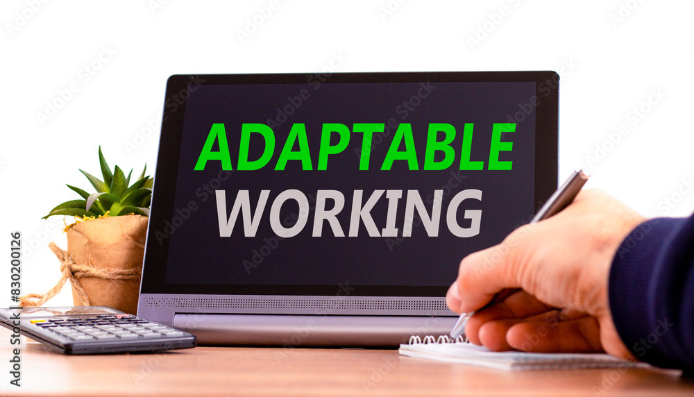 Adaptable working symbol. Concept words Adaptable working on beautiful black pad. Beautiful white background. Businessman hand. Calculator. Business Adaptable working concept. Copy space. Adaptable working symbol. Concept words Adaptable working on beautiful black pad. Beautiful white background. Businessman hand. Calculator. Business Adaptable working concept. Copy space.