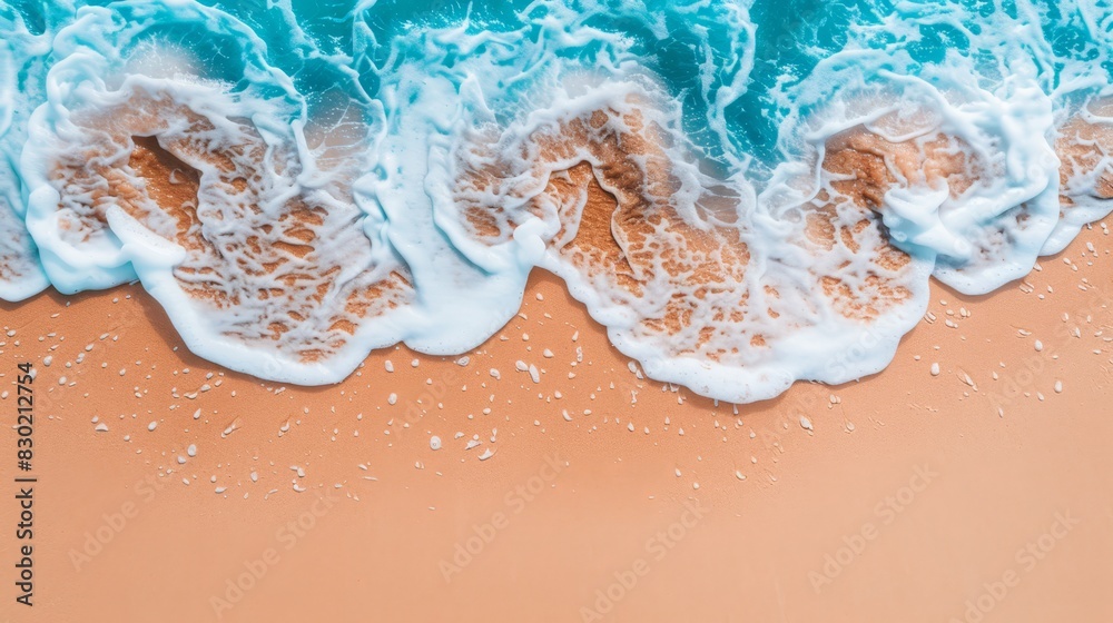 beach with waves crashing onto sand, blue ocean backdrop, white foamy wave rising from shore