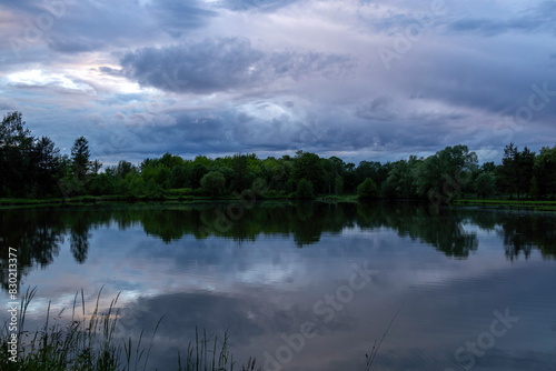 Pond under dramatic skies before nightfall