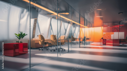 Beautiful blurred background of a modern office interior in gray tones with panoramic windows, glass partitions and orange color accents.
 photo