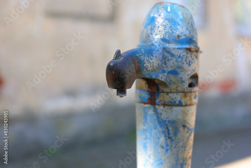 A spider sitting on an old water pump