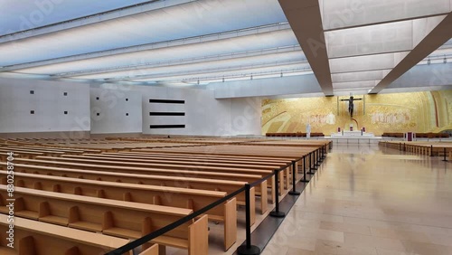 Interior of the modern Minor Basilica of Most Holy Trinity at Fatima, Portugal. View over the altar, aisles and pews. Fatima is a major Marian Shrine for pilgrims photo