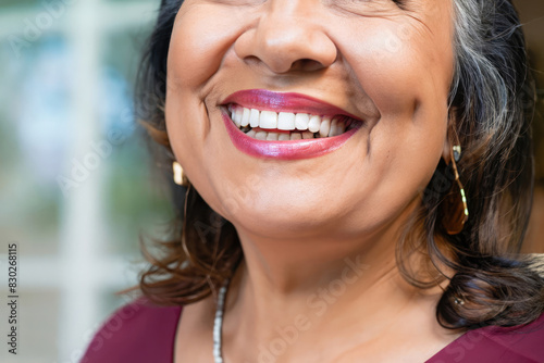 portrait of a woman smiling, smile of a mature latino, woman with perfect teeth, dental care