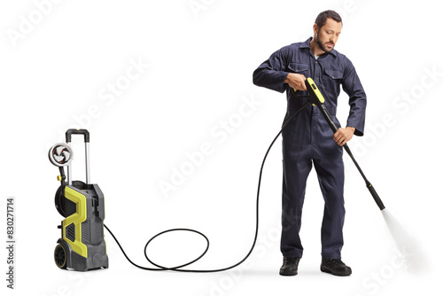 Worker cleaning with a high pressure washer machine