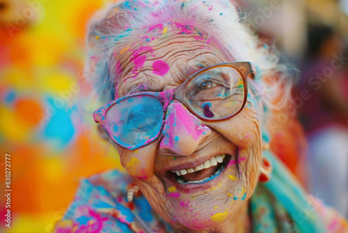 old woman happy in holi colors