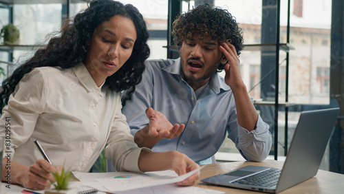 Professional mentor Arabian businesswoman help teach Indian worker analysis explain web project laptop difficult business quarrel conflict misunderstanding teamwork woman man use computer at office