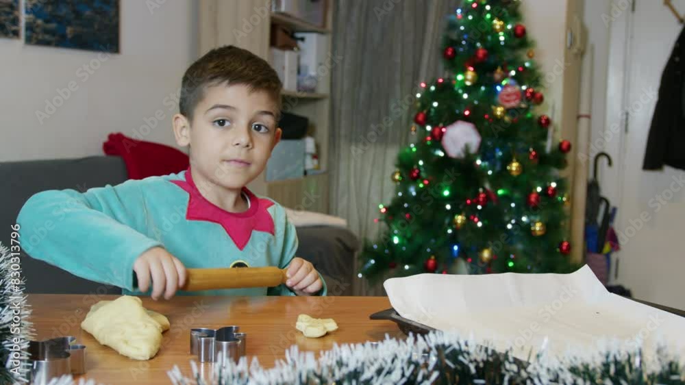 Cute child dressed in elf costume making gingerbread cookies. High quality 4k footage Cute child dressed in elf costume making gingerbread cookies. High quality 4k footage