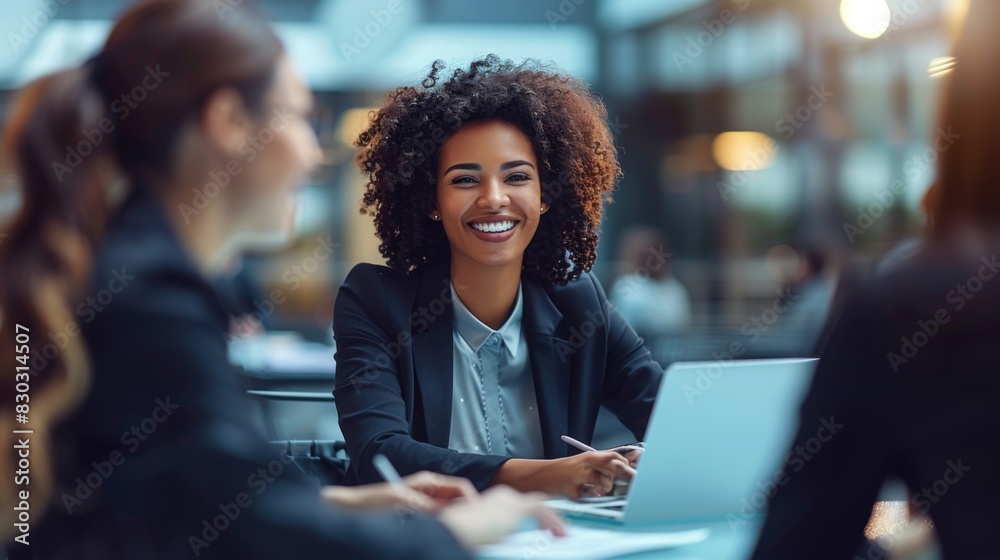 Two businesspeople working together on a project, with one smiling at the camera. Two businesspeople working together on a project, with one smiling at the camera.