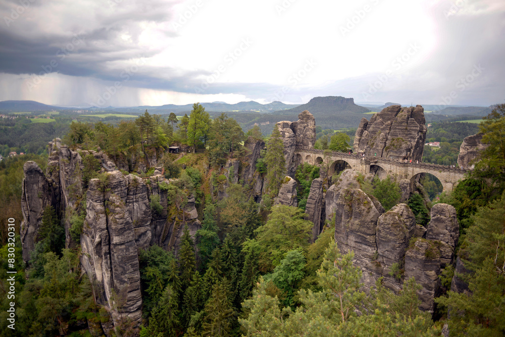 Obraz premium Bastei Bridge (Basteibrücke) with approaching thunderstorm in Saxony, Germany