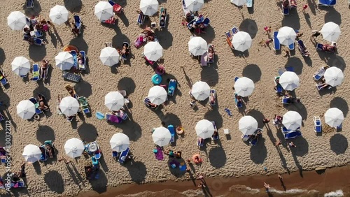 Aerial view of the sand beach, sunbeds and umbrellas of Sunny Beach in Bulgaria. Summer holidays in Europe. Aerial video, drone view. Summer background
