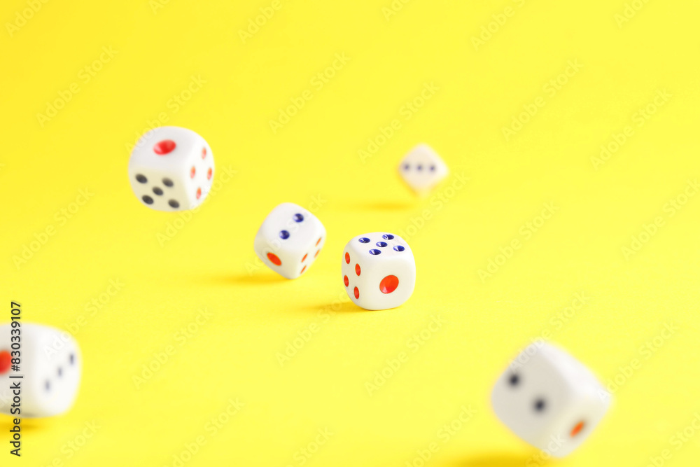 Many white game dices falling on yellow background. Space for text Many white game dices falling on yellow background. Space for text
