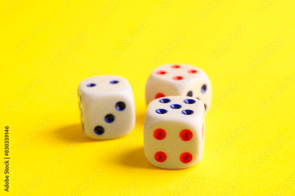 Three white game dices on yellow background, closeup Three white game dices on yellow background, closeup