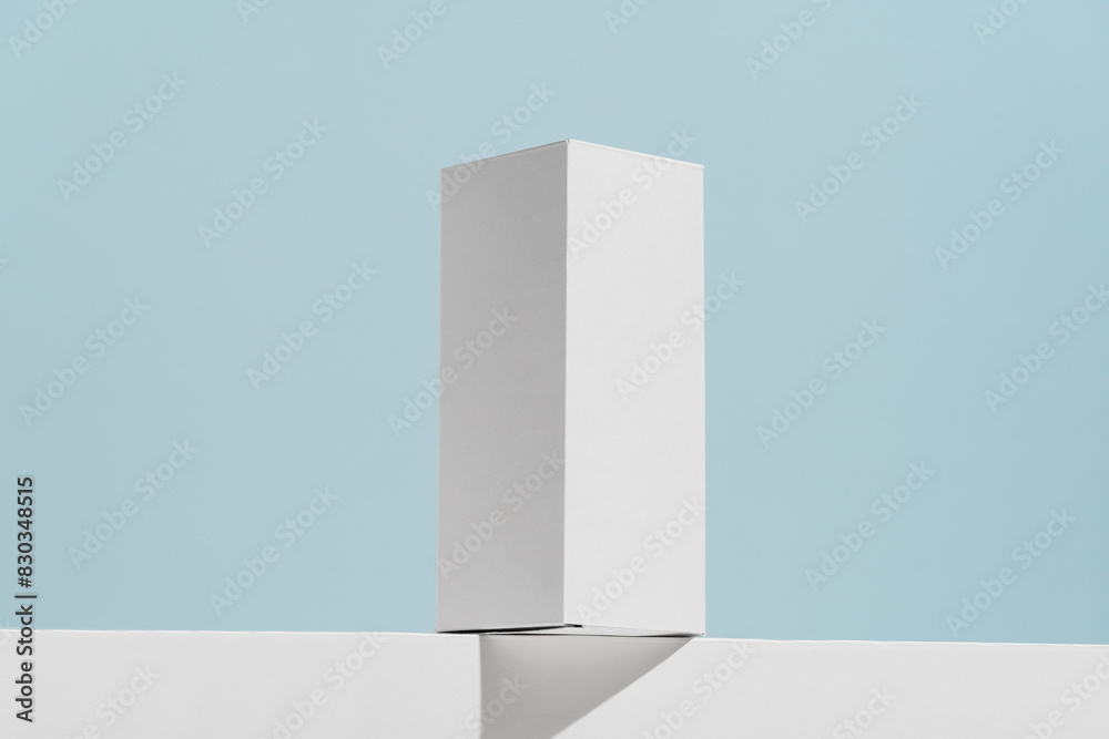 White mockup box for syrup, tablets or mouthwash with drop shadow on blue background. The concept of pharmacy, advertising of goods, medicines and dietary supplements White mockup box for syrup, tablets or mouthwash with drop shadow on blue background. The concept of pharmacy, advertising of goods, medicines and dietary supplements